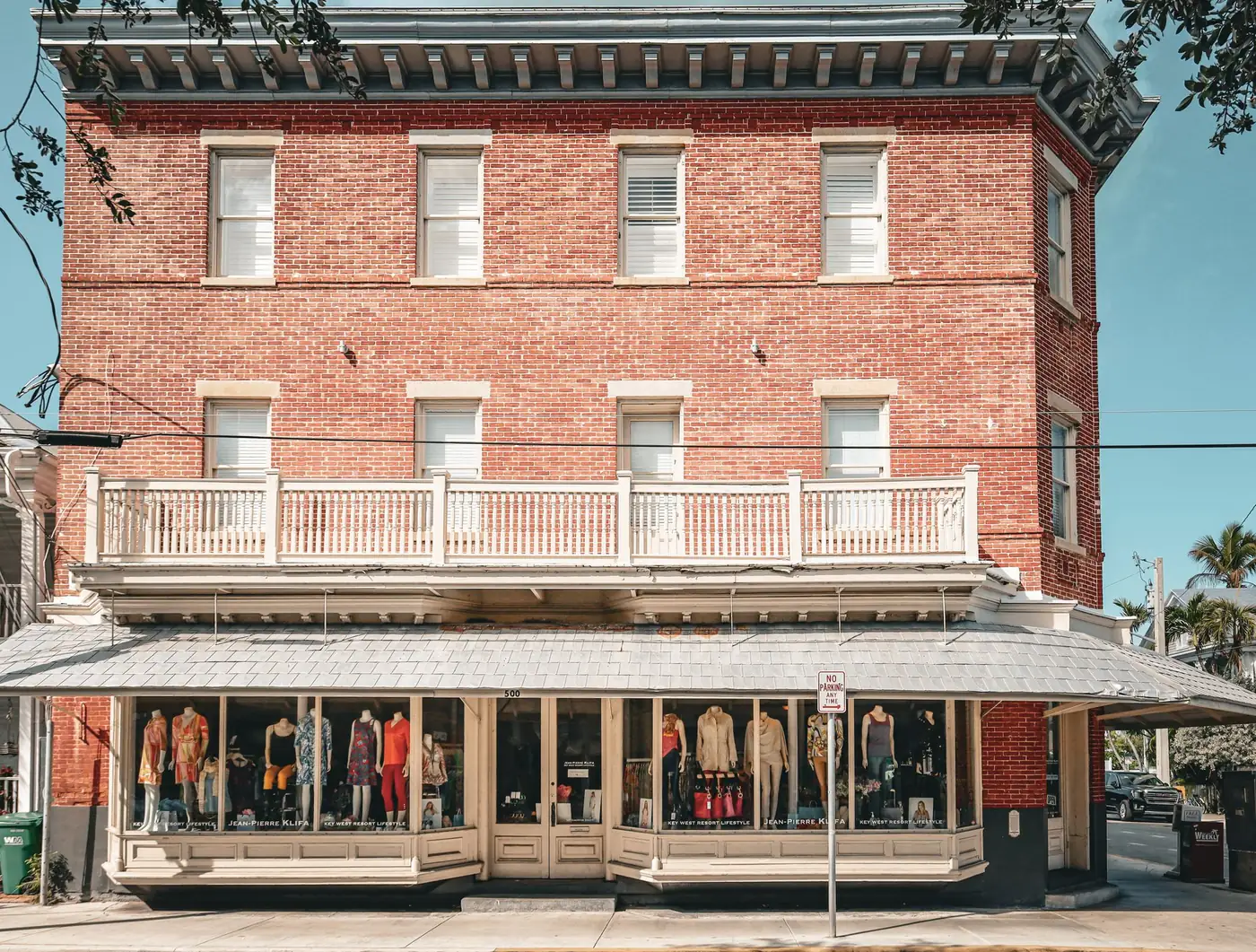 Red brick mixed-use building with a retail storefront on the ground floor and offices above